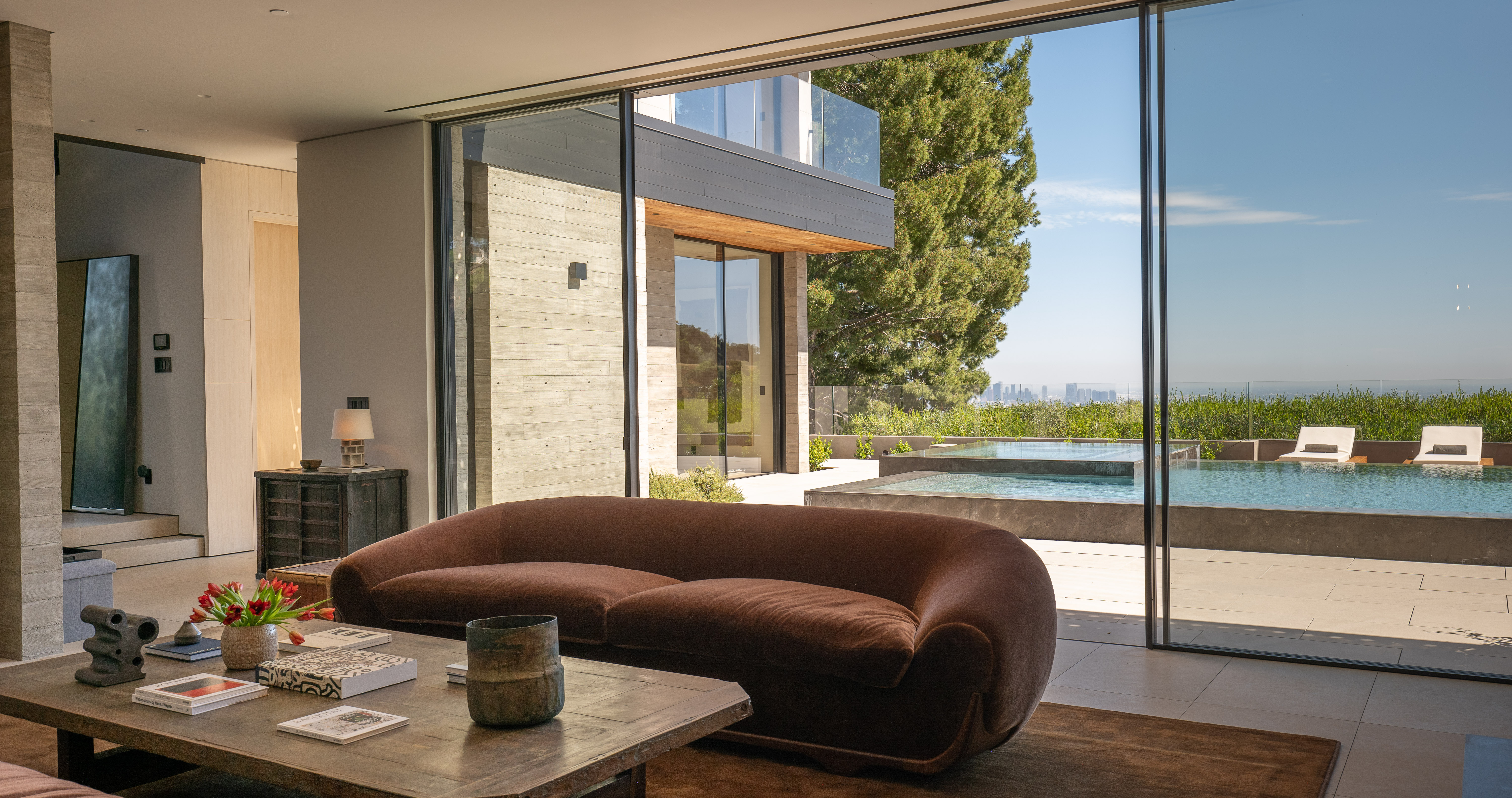 Living room — wall of glass opening to pool