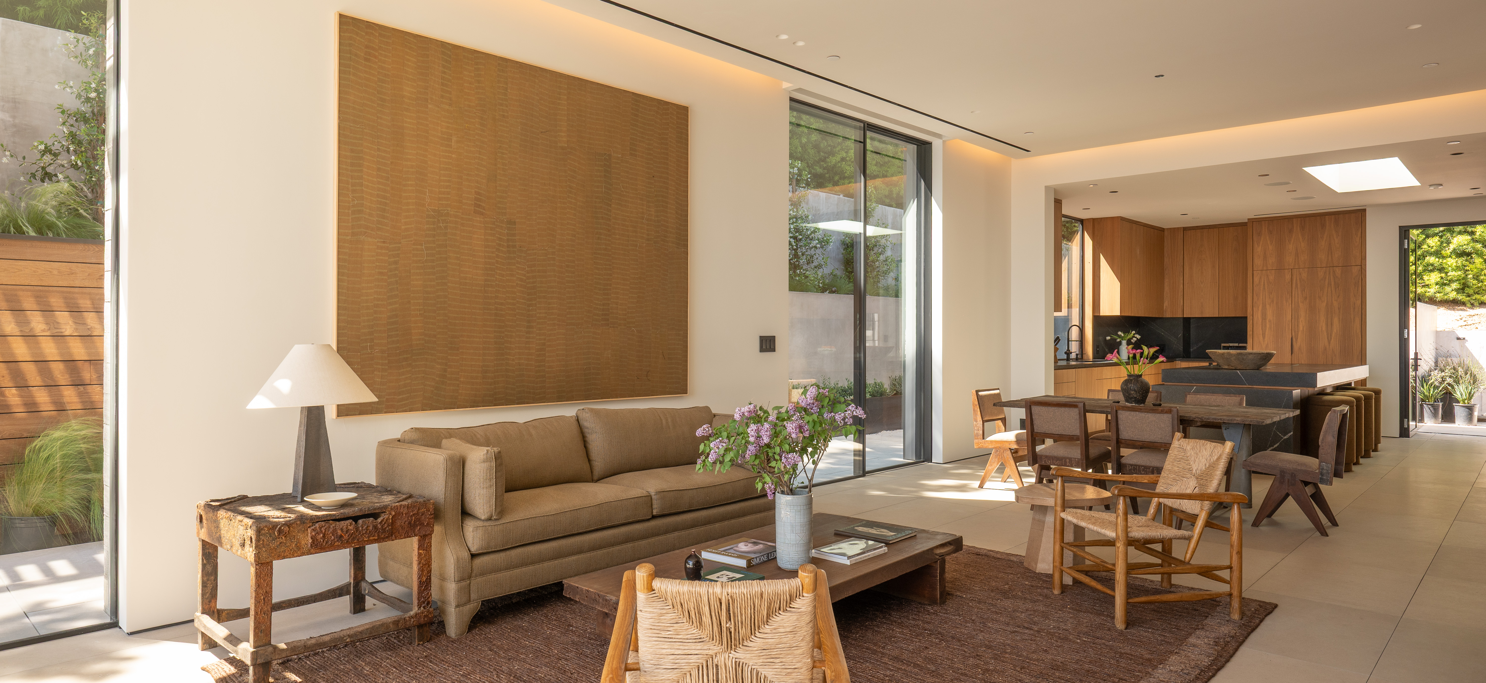 Living room — cove light, art, limestone floor